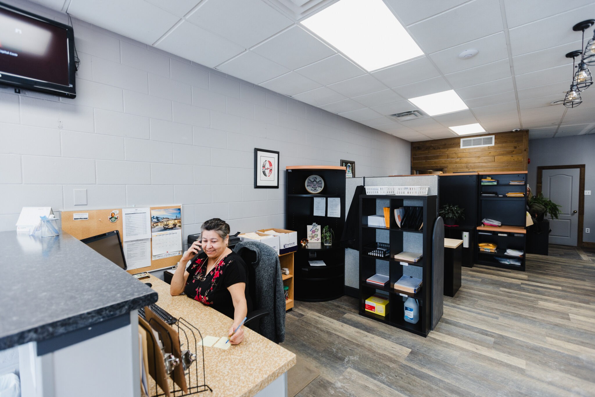 The front desk of the Warkentin office in Winnipeg, with a team member taking a call