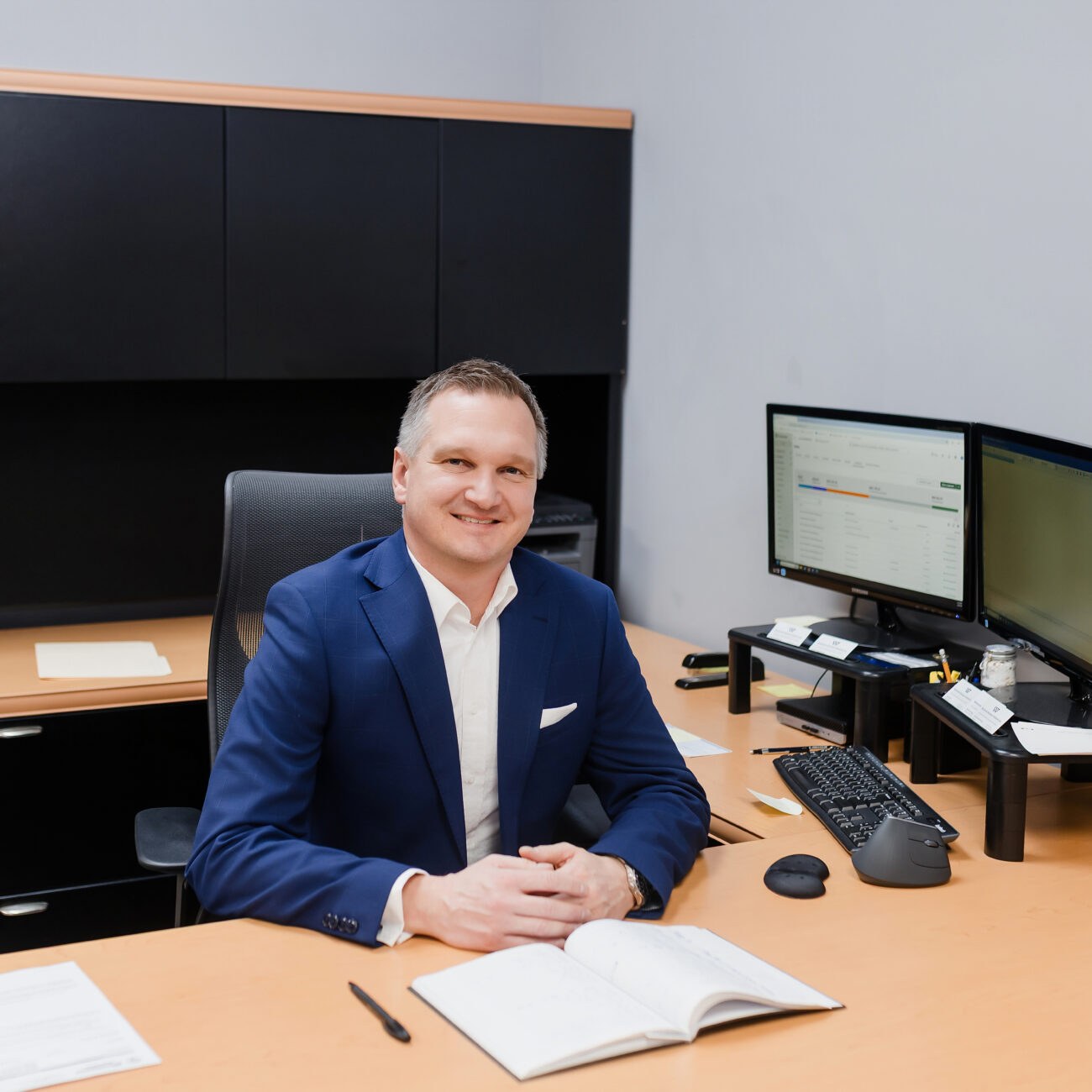 A member of the Warkentin team at his desk in the Winnipeg office